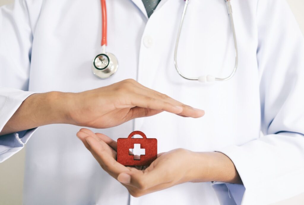 doctor con una cajita roja entre las manos